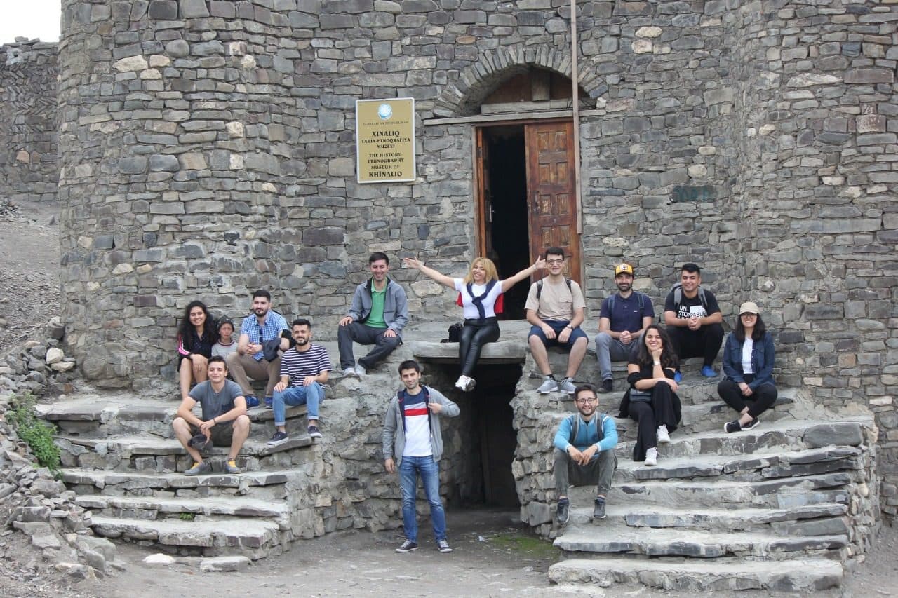 Members on an LTC trip at a historic stone building