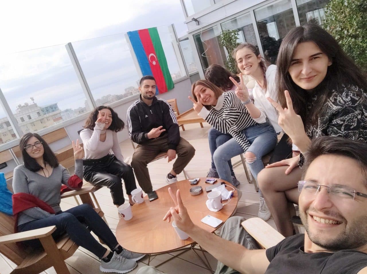 Members around a table at LTC, the flag of Azerbaijan behind them